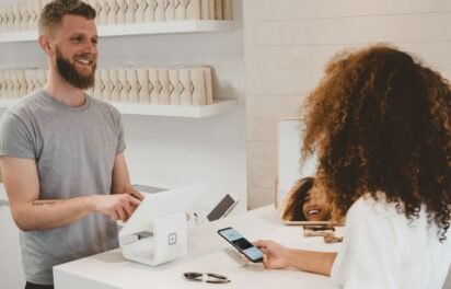 how much does an ecommerce website cost — customer paying at a store checkout how much does an ecommerce website cost — customer paying at a store checkout