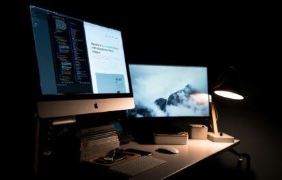 how much does a small business website cost — designer desk with website design on screen how much does a small business website cost — designer desk with website design on screen