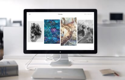 Website redesign cost guide — designer updating a business website layout Website redesign cost guide — designer updating a business website layout